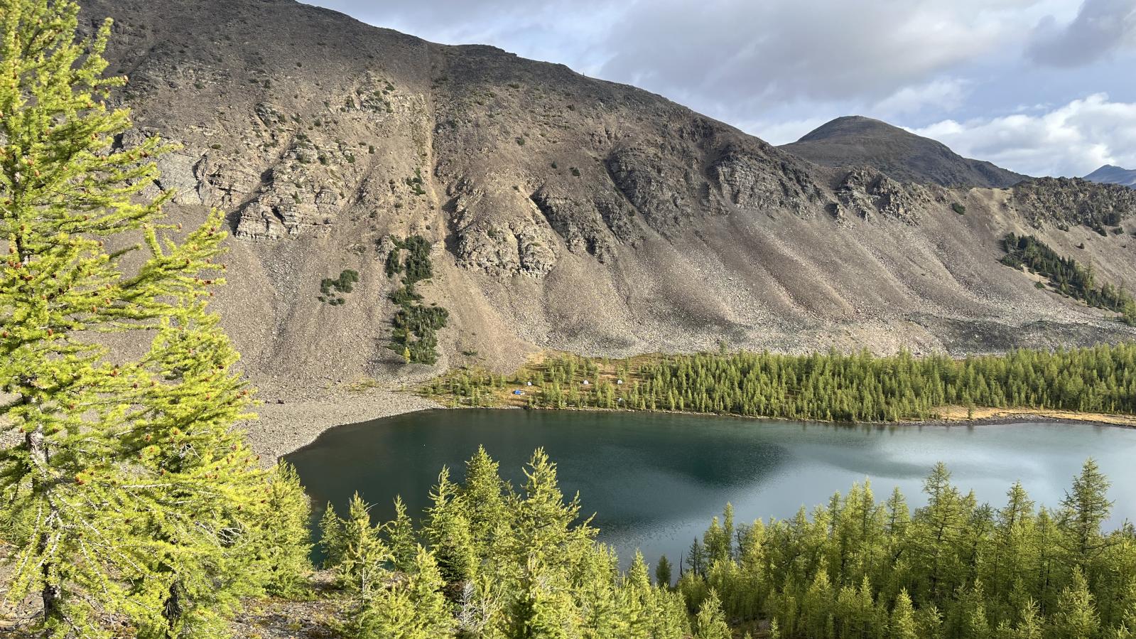 Exploration camp setting with lake and mountains in background at the Findlay Project of Southeast BC