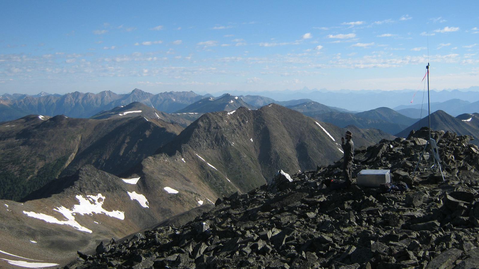An Eagle Plains employee at the top of a mountain