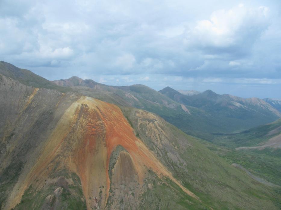 Pelly Mountain Project - Ice Claims Gossanous Volcanics with Drill Pad at Center of Brown Weathered Volcanics