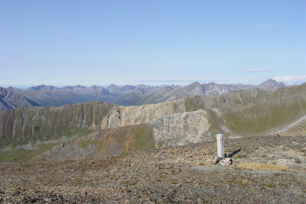 Limestone Stratigraphy (light color rock) Underlain by Pelly Vocanics in the Core of an Anticline - Looking Eastward