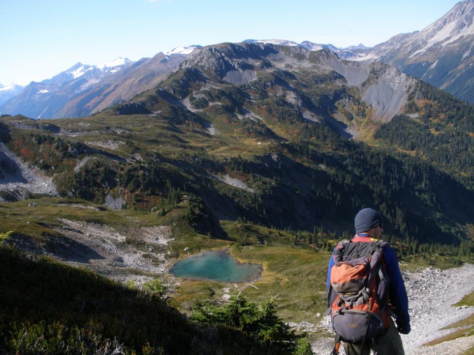 Geological Crew Memeber Overlooking the Exploration Camp the West Cu-Au Zone of the Elsiar Property in Northwestern British Columbia Geological Crew Memeber Overlooking the Exploration Camp the West Cu-Au Zone of the Elsiar Property in Northwestern British Columbia